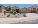 Single story home with a three-car garage and desert landscaping at 20767 N Bustos Way, Maricopa, AZ 85138