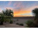 Sunset view over a desert landscape with retaining wall at 20876 N Canyon Whisper Dr, Surprise, AZ 85387