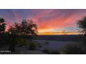 Sunset view over a desert landscape with retaining wall at 20876 N Canyon Whisper Dr, Surprise, AZ 85387