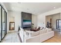 Spacious living room with white sectional sofa and a modern fireplace at 23491 N 125Th Pl, Scottsdale, AZ 85255