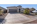 Charming single-story home featuring a two-car garage and desert landscaping at 24134 N Cotton Cir, Florence, AZ 85132