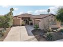 Single story home with two car garage, desert landscaping, and a courtyard entry at 27379 N Makena Pl, Peoria, AZ 85383