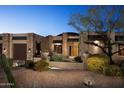 Desert home with stone accents and a three-car garage at 28492 N 95Th Pl, Scottsdale, AZ 85262