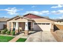 Low angle shot of a single-story home with a well-kept lawn and a two-car garage at 4342 E Sagebrush St, Gilbert, AZ 85296