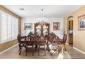 Formal dining room featuring a crystal chandelier, hardwood floors, and ample seating for eight at 476 E Atlantic Dr, Casa Grande, AZ 85122