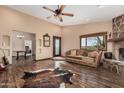 Spacious living room with beautiful hardwood floors, stone fireplace, and lots of natural light at 50031 N 27Th Ave, New River, AZ 85087