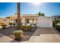 Tan manufactured home with white lattice-covered carport at 5807 E Leonora St, Mesa, AZ 85215