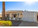 Front view of a tan manufactured home with a carport at 5807 E Leonora St, Mesa, AZ 85215