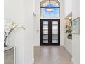 Bright foyer features a tall, arched window above a frosted glass door, and decor shelves at 7705 E Doubletree Ranch Rd # 56, Scottsdale, AZ 85258