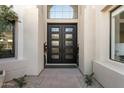 Close up of the main entrance featuring a modern frosted glass door and light colored stucco at 7705 E Doubletree Ranch Rd # 56, Scottsdale, AZ 85258