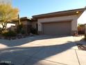 Single-story home with desert landscaping and two-car garage at 7741 E Balao Dr, Scottsdale, AZ 85266