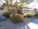 Single-story home with desert landscaping and two-car garage at 7741 E Balao Dr, Scottsdale, AZ 85266