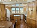 Well-lit kitchen featuring wood cabinets, an island, bright countertops and modern appliances at 7750 E Broadway Rd # 400, Mesa, AZ 85208