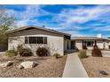 Charming single story home with landscaped front yard and walkway at 8620 E Starlight Way, Scottsdale, AZ 85250