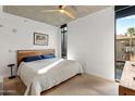 Bright bedroom with a king-size bed and large window at 100 W Portland St # 401, Phoenix, AZ 85003