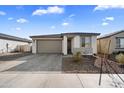 Well-maintained home featuring a two-car garage and attractive brick driveway, landscaped with desert plants at 11517 E Unity Ave, Mesa, AZ 85212