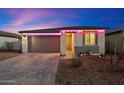 Attractive single-Gathering home with a two-car garage, stylish brick driveway, and colorful pink lighting accents at 11517 E Unity Ave, Mesa, AZ 85212