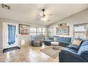 Spacious living room featuring a sectional sofa and a ceiling fan at 12858 W Wilshire Dr, Avondale, AZ 85392