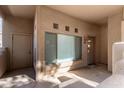 The home's entryway featuring the front door, small sidelight window and an outdoor storage closet at 1351 N Pleasant Dr # 1102, Chandler, AZ 85225