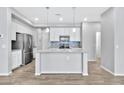 Open concept kitchen with stainless steel appliances and a large island at 1959 E Hampton Ln # 102, Gilbert, AZ 85295