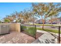 Private patio area with a view of a tree-lined street at 1959 E Hampton Ln # 102, Gilbert, AZ 85295