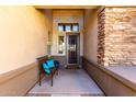 Welcoming front porch with stone accents, cozy bench, and views of the home's exterior at 20540 N 86Th Ln, Peoria, AZ 85382