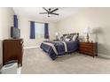 Calm bedroom with a ceiling fan, a double bed, neutral paint, and lots of natural light at 2306 N Floyd Dr, Mesa, AZ 85215