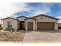 Charming single-story home with a three car garage, desert landscaping, and brick accents at 2306 N Floyd Dr, Mesa, AZ 85215