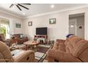 Cozy living room features neutral paint, comfortable seating and a ceiling fan at 2306 N Floyd Dr, Mesa, AZ 85215