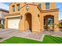 Front entrance with arched entryway, stone walkway, and landscaping at 2404 E Gillcrest Rd, Gilbert, AZ 85298