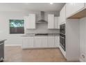 Modern kitchen with white cabinets, stainless steel appliances, and a large window at 3218 N Lafayette Dr, Florence, AZ 85132