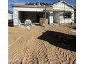 New construction home with tan exterior and unfinished landscaping at 38141 N Stallion St, San Tan Valley, AZ 85140