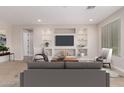 Bright living room features built-in shelving and a cozy seating area at 5575 W Cinder Brook Way, Florence, AZ 85132