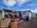 Backyard patio with seating, fountain, and grill at 650 N Hawes Rd # 2713, Mesa, AZ 85207