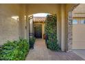 Inviting entryway with wrought iron gate and lush landscaping at 7325 E El Caminito Dr, Scottsdale, AZ 85258