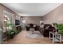 Living room with hardwood floors, couches and a large TV at 8434 N 54Th Dr, Glendale, AZ 85302