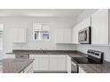 Well-equipped kitchen features granite counters and stainless steel appliances at 8470 W Mantle Way, Florence, AZ 85132