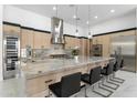 Spacious kitchen featuring an island with a marble countertop and bar stool seating at 12560 E Cochise Dr, Scottsdale, AZ 85259