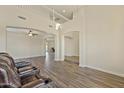 Open living room featuring hardwood floors and a lofted ceiling at 1278 E Geona Ct, San Tan Valley, AZ 85140