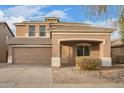 Home exterior featuring a two-car garage and covered entryway, set on a lot with desert landscaping at 15118 W Lincoln St St, Goodyear, AZ 85338