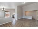 Bright living room with wood-look tile floors and an open floor plan at 15145 W Elko Dr, Surprise, AZ 85374