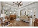 Comfortable living room featuring hardwood floors, modern ceiling fan, and ample natural light at 1560 W Augusta Ave, Phoenix, AZ 85021