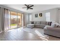 Spacious living room with L-shaped sectional sofa and wood-look floors at 1631 E Paul Dr, Casa Grande, AZ 85122