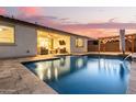 Stunning pool and patio area with outdoor lighting, perfect for entertaining at 19042 W Clinton St, Surprise, AZ 85388