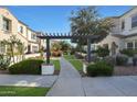 Community walkway with pergola and lush landscaping at 2477 W Market Pl # 55, Chandler, AZ 85248