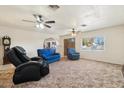 Living room with two blue armchairs and a black massage chair at 3432 N 86Th Ave, Phoenix, AZ 85037