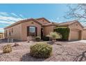 Tan stucco house with a tile roof and neatly landscaped yard at 5077 S Barley Way, Gilbert, AZ 85298