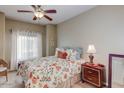 Bedroom with floral bedding, nightstand and ceiling fan at 5350 E Deer Valley Dr # 4248, Phoenix, AZ 85054