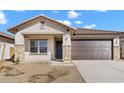 Inviting single-story home with stone accents, desert landscaping, and a covered entry at 7548 W Park St, Laveen, AZ 85339