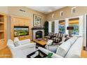 Comfortable living room with a fireplace and bright natural light at 8923 E Mountain Spring Rd, Scottsdale, AZ 85255